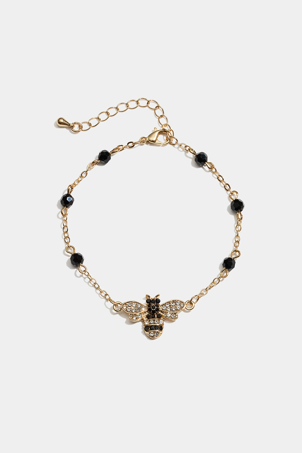 Guldfärgat armband med bi-berlock och svarta glasstenar i gruppen Smycken / Armband / Tunna hos Glitter (251002382000)