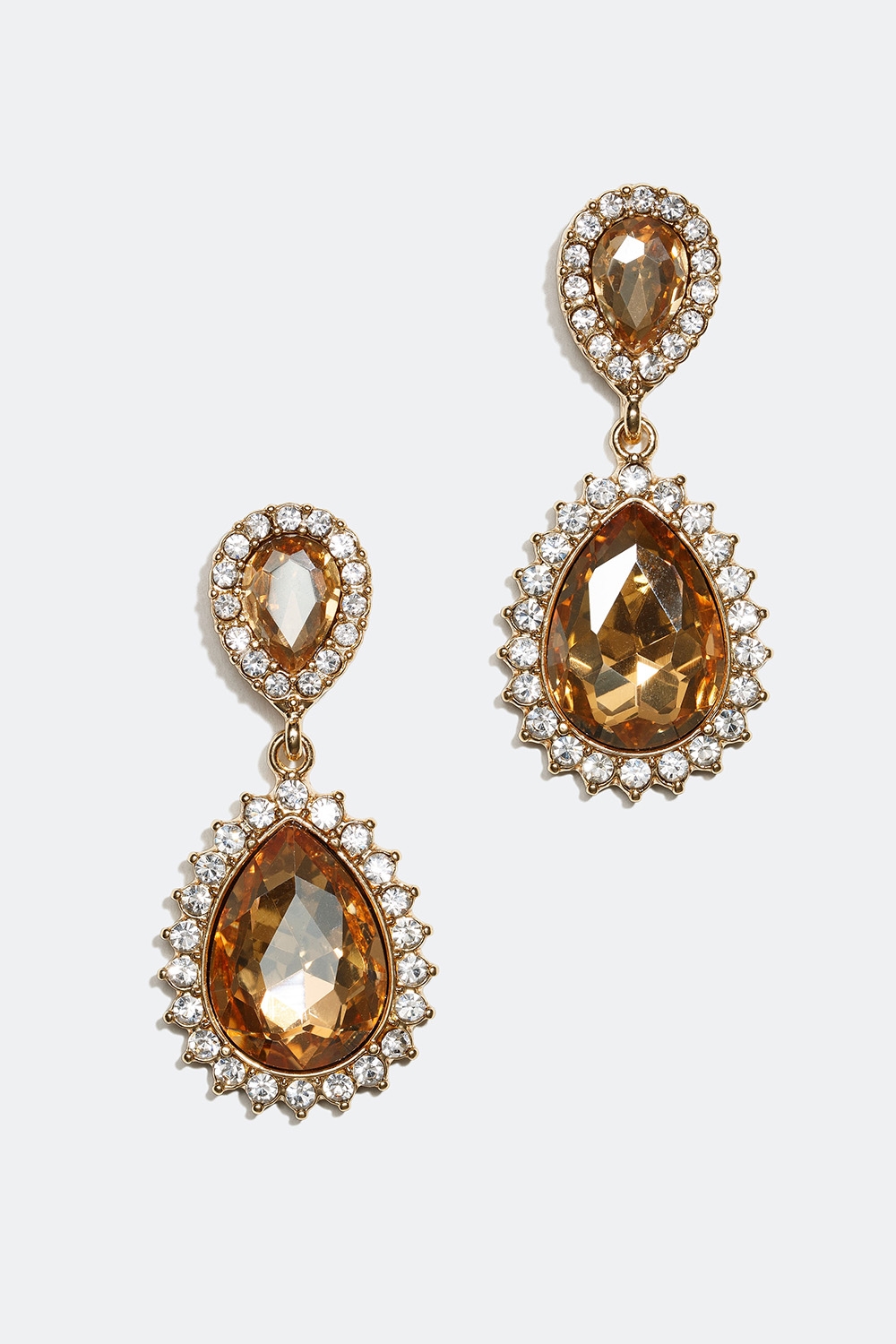 Droppformade örhängen med vita och guldfärgade glasstenar i gruppen Smycken / Örhängen hos Glitter (253002548300)