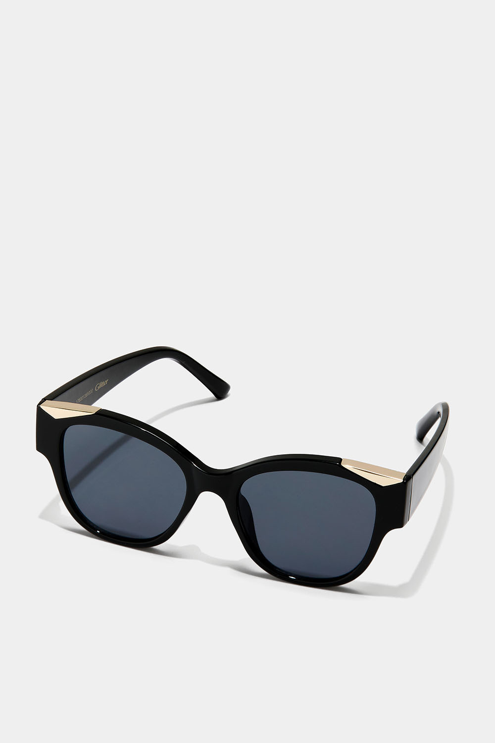 Solglasögon med guldfärgad detalj på bågen