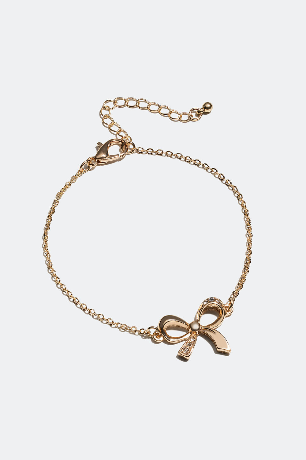 Guldfärgat armband med rosett och glasstenar