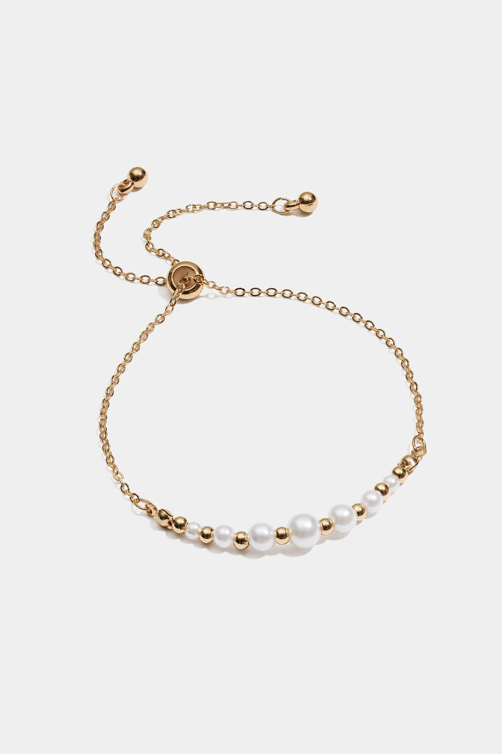 Armband med vita och guldfärgade pärlor