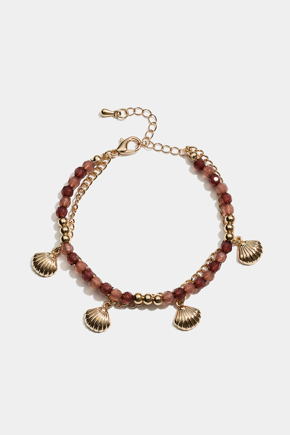 Dubbelarmband med bruna pärlor och snäckor