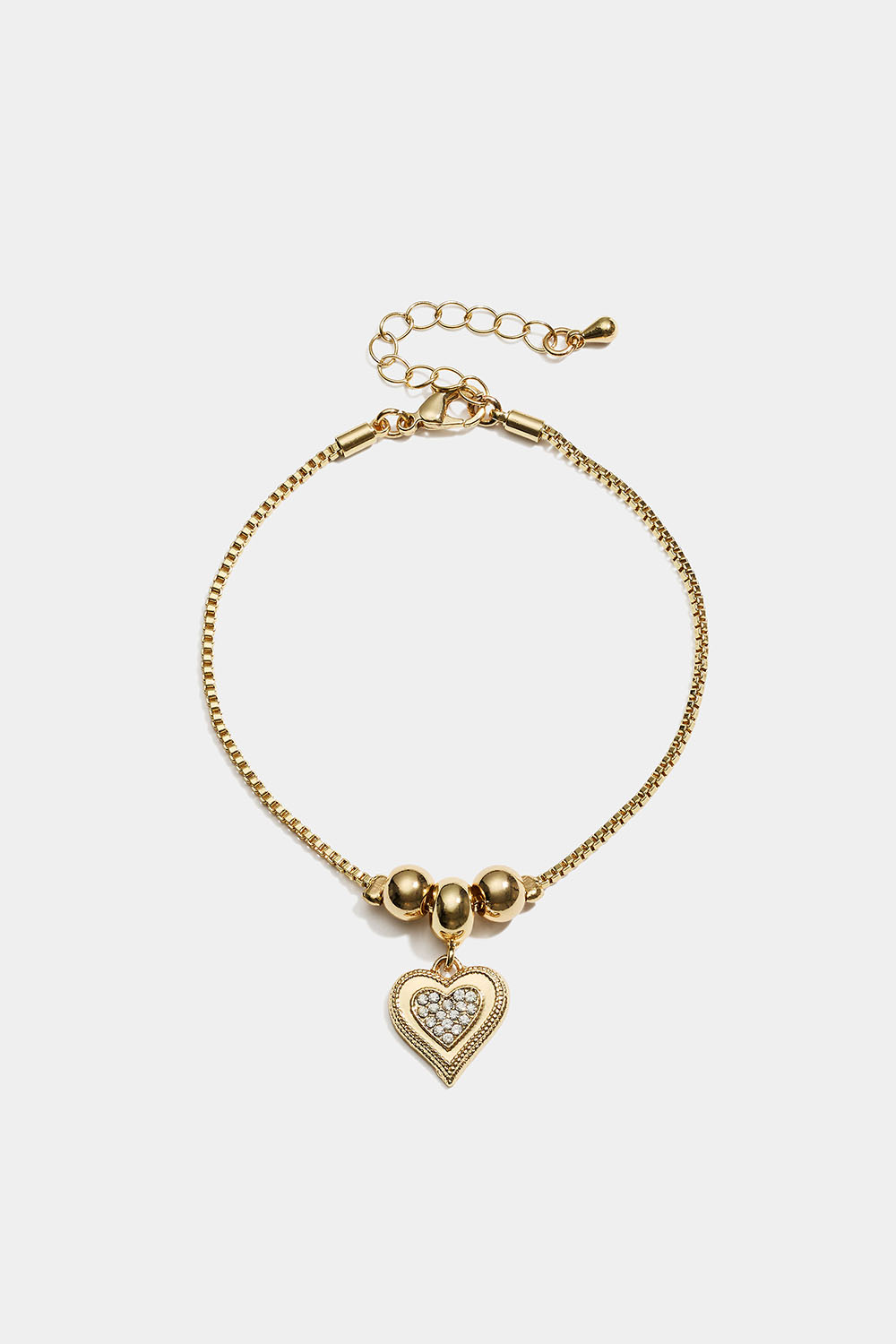 Guldfärgat armband med hjärtformad berlock