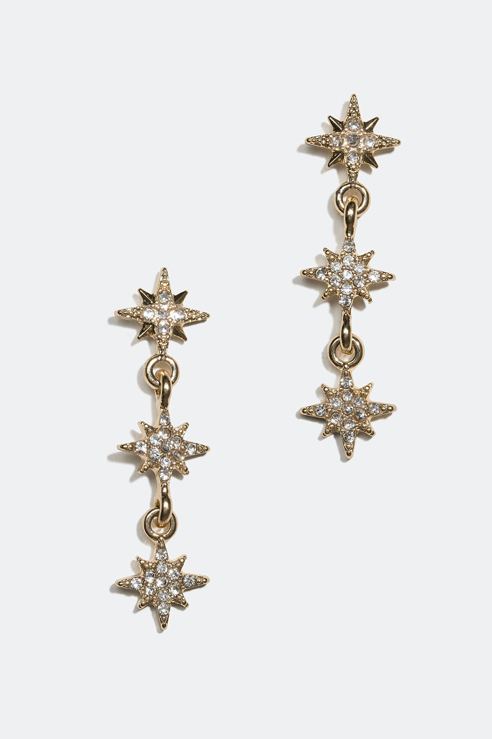 Guldfärgade örhängen med små stjärnor och glasstenar