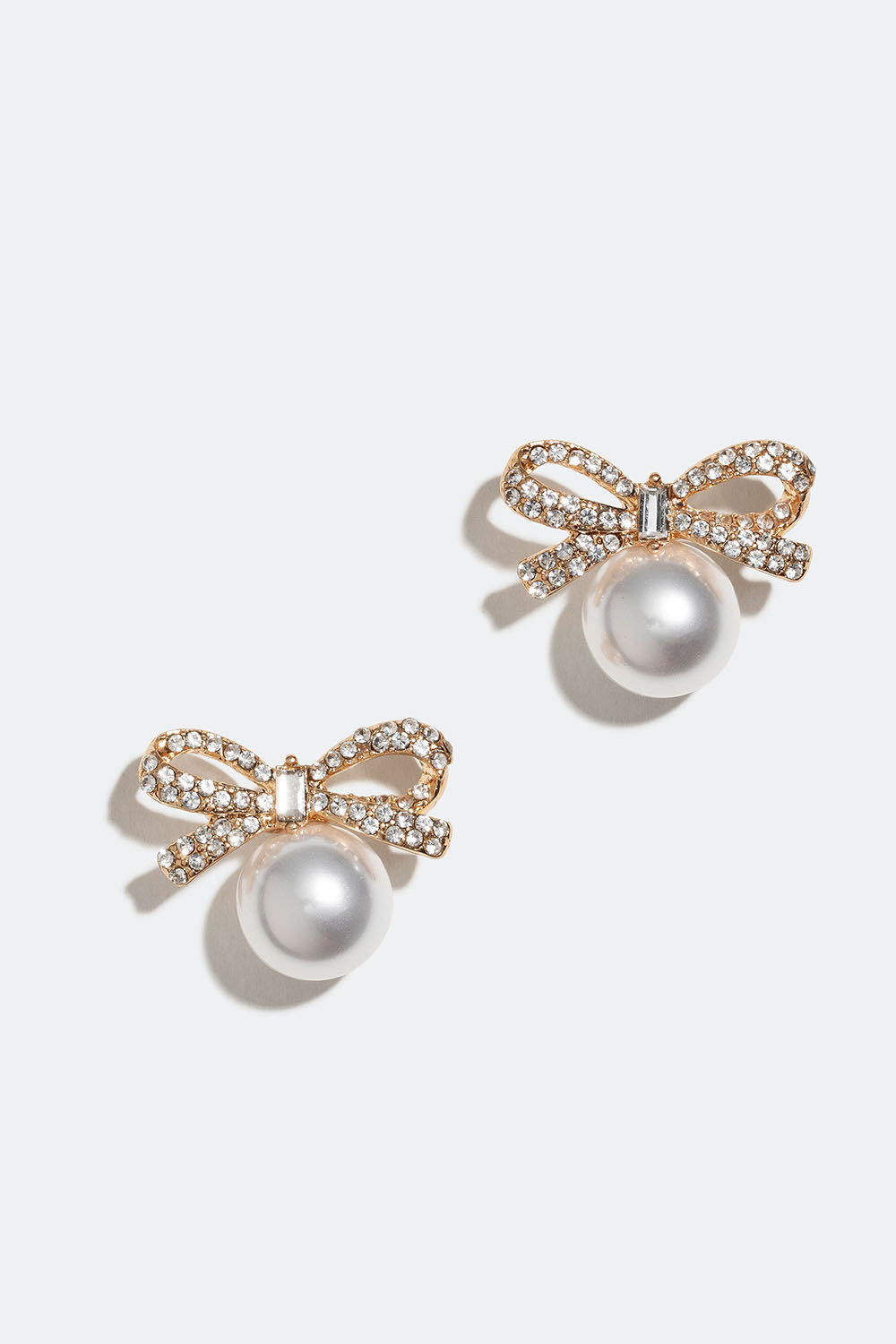 Guldfärgade örhängen i strass med rosetter och pärlor