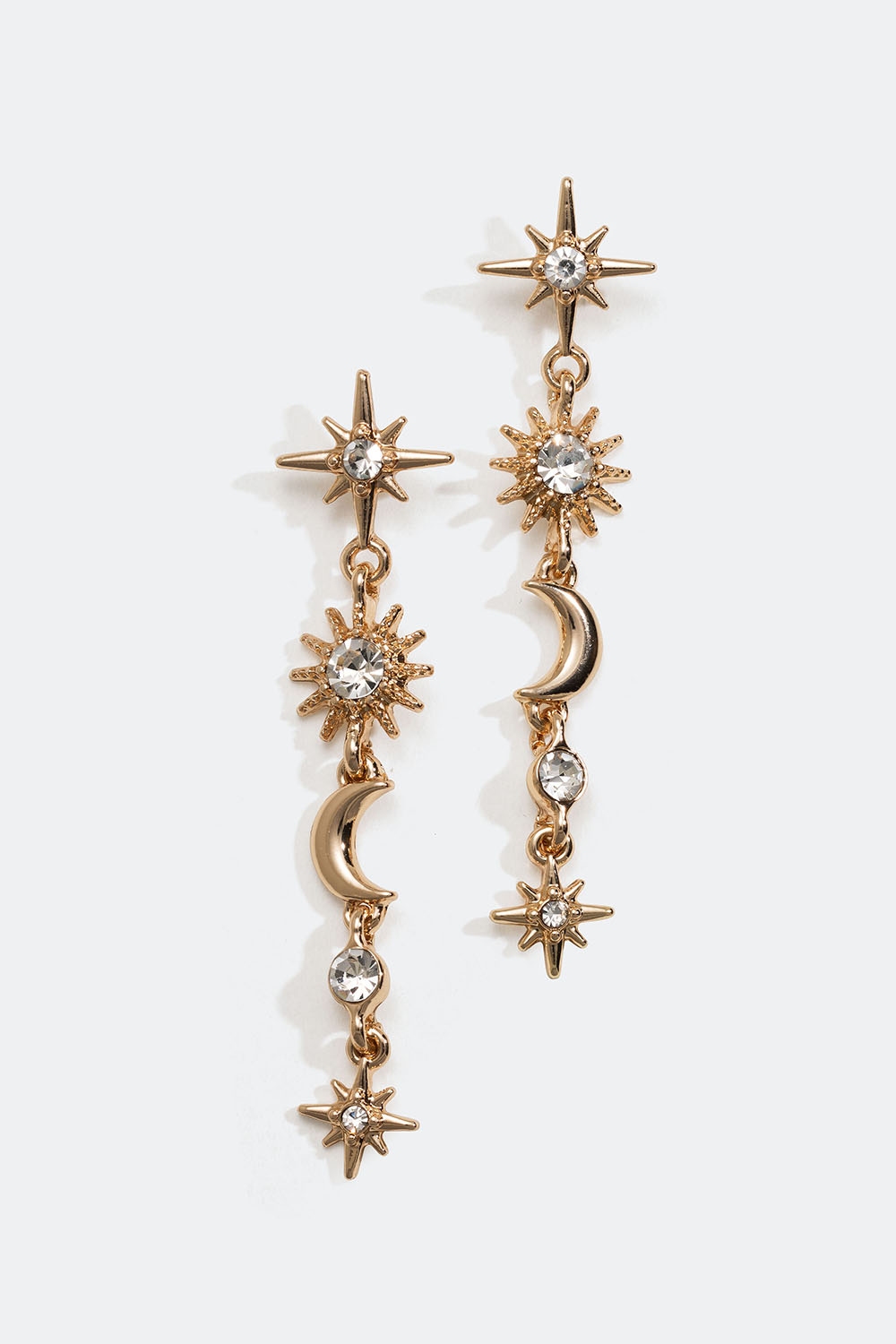 Guldfärgade örhängen med hängen av stjärnor och månar