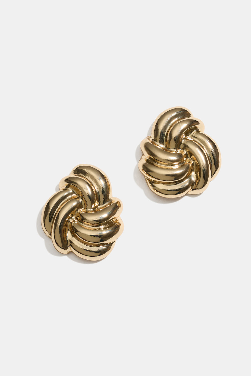 Stora guldfärgade örhängen med knut