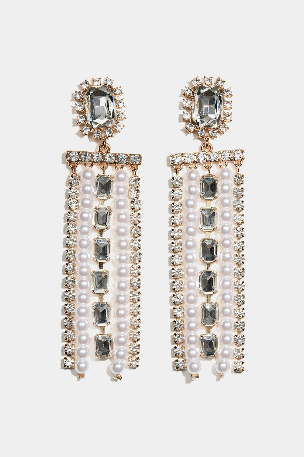 Guldfärgade örhängen med rektangulär glassten och hängande strass- och pärllänkar