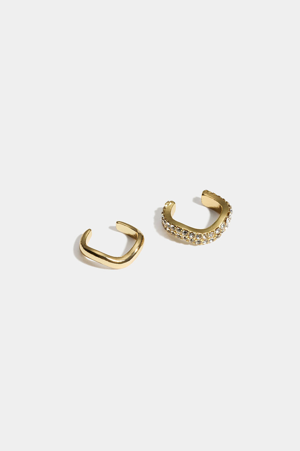 Vågiga guldfärgade ear cuffs med glasstenar, 2-pack