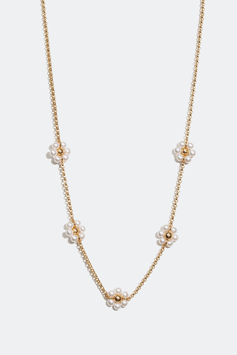Guldfärgat halsband med vita blommor