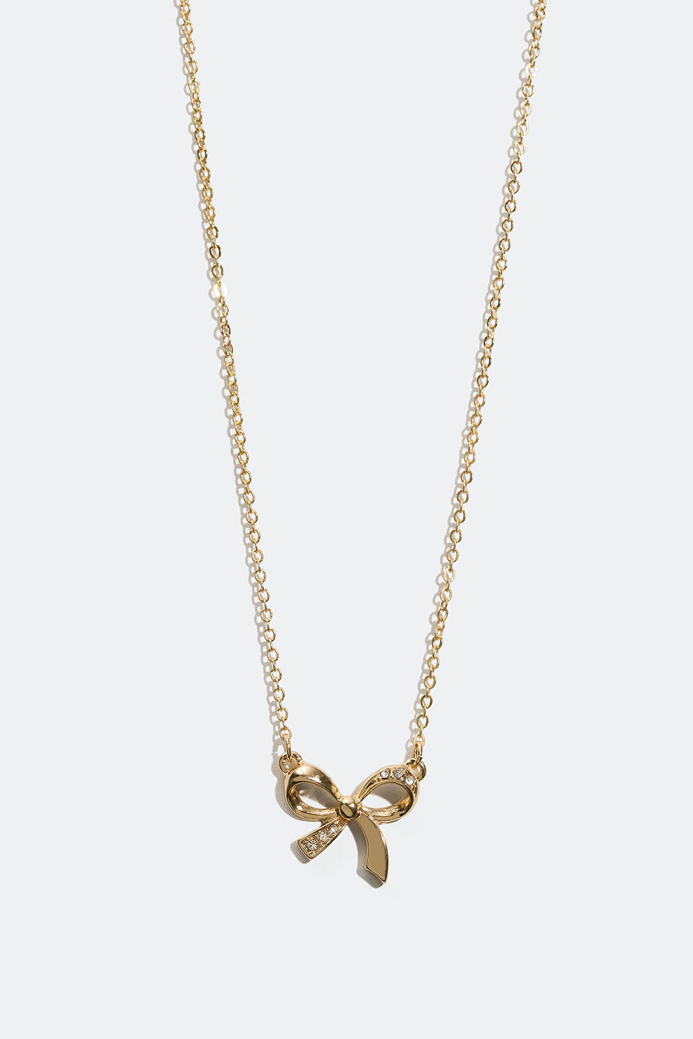 Guldfärgat halsband med rosett och glasstenar