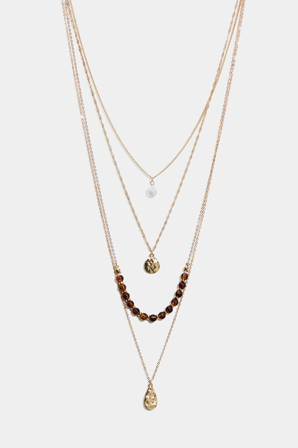 Långt halsband med fyra kedjor och hängsmycken