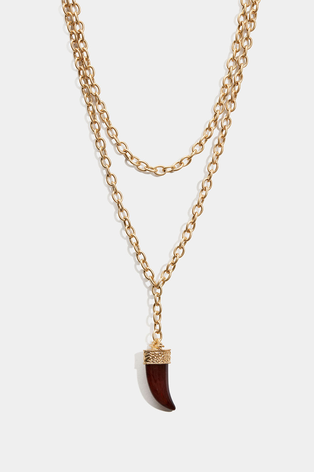 Guldfärgat halsband med vinröd tandsberlock