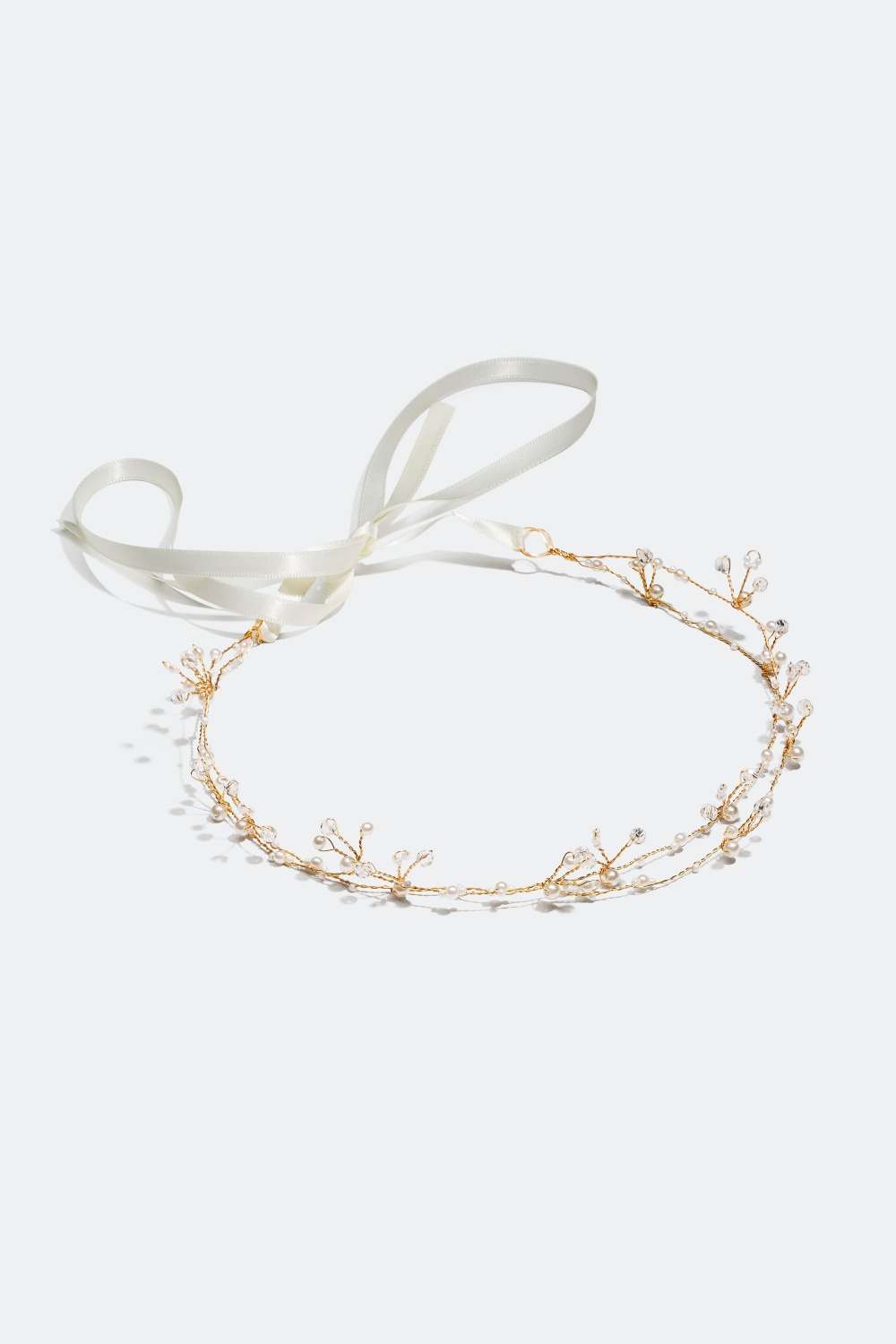 Guldfärgad hårdekoration med stenar och pärlor 