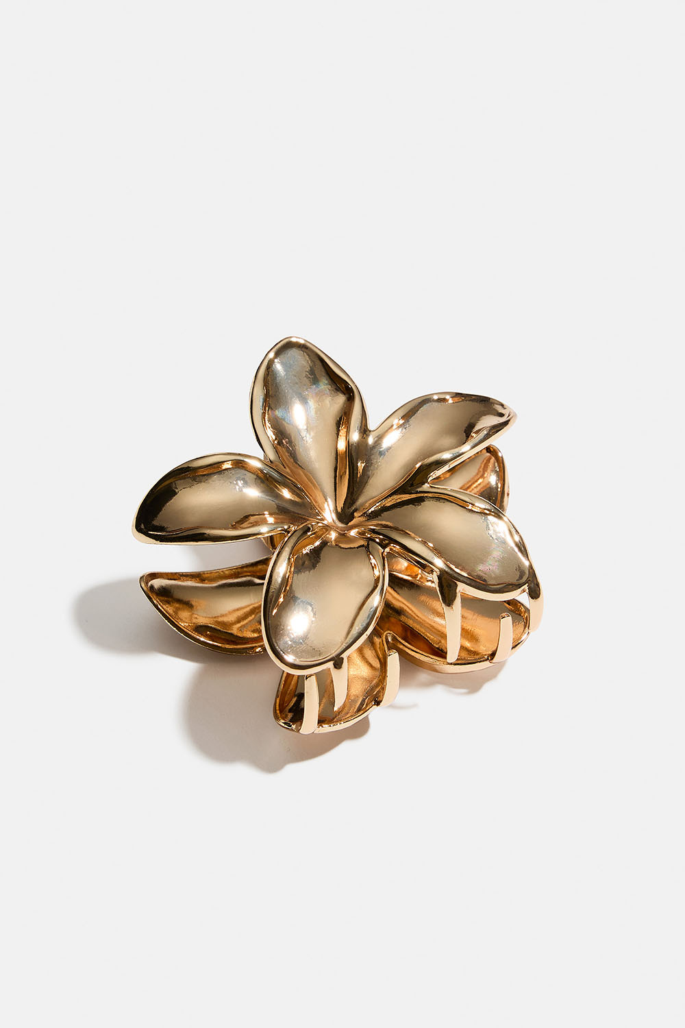 Blomformad hårklämma i guldfärgad metall
