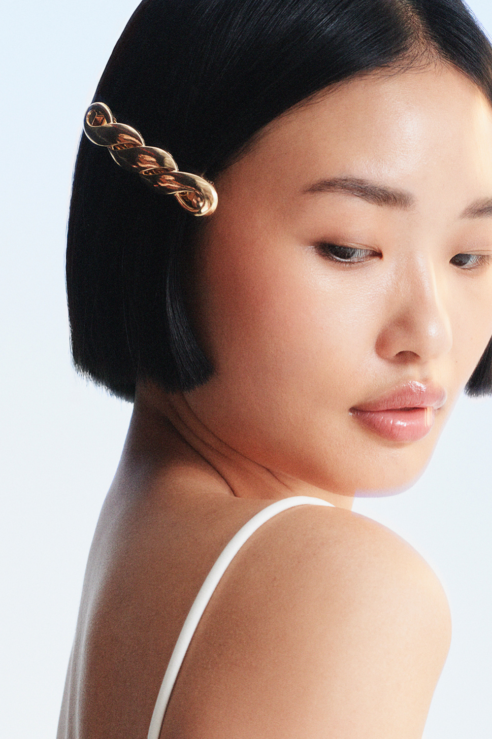 Tvinnat guldfärgat hårspänne