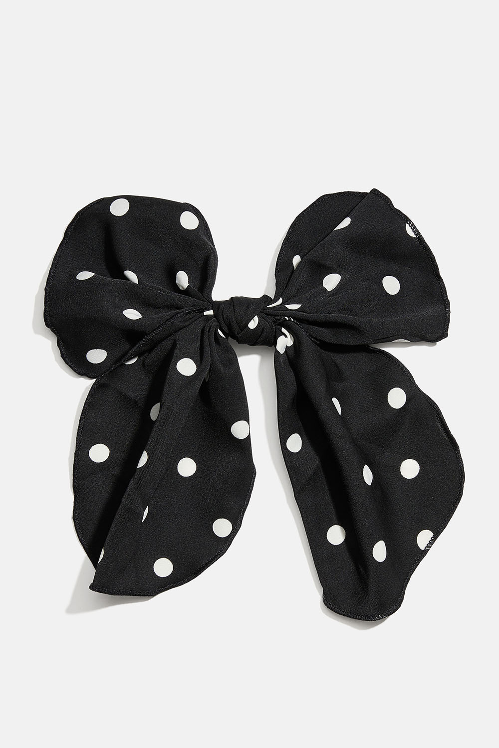 Hårspänne med svart rosett i prickigt mönster