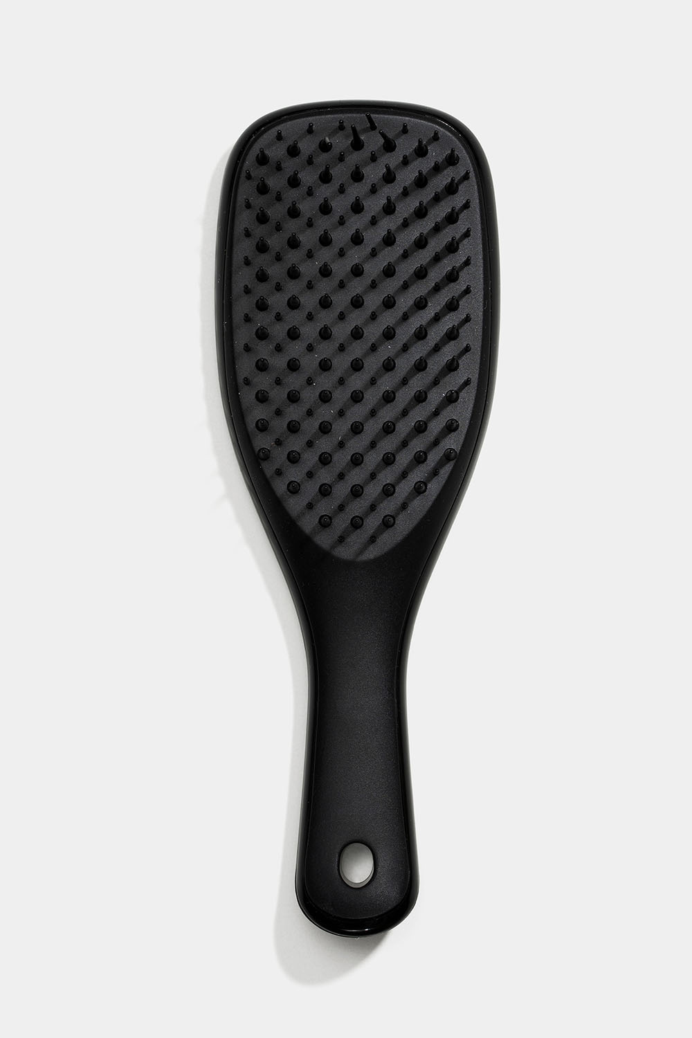 Liten svart hårborste detangler